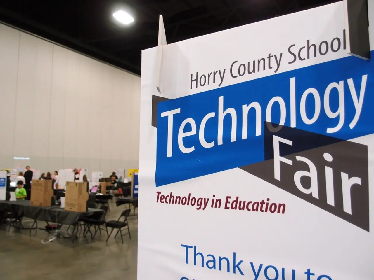 In the picture we can find one hoarding is written something about the technology fair. In the...